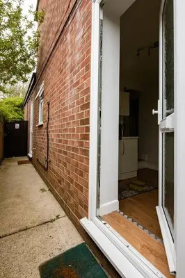 an open door to a brick building with a porch at Fourwinds in Maldon