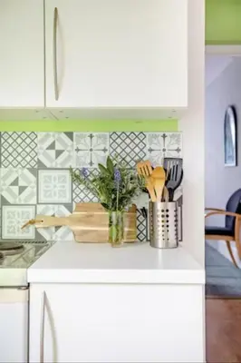 a kitchen with white cabinets and a white counter top at Fourwinds in Maldon