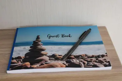 a book with a wreck book and a pencil on a beach at Platinum lodge on Carlton Meres holiday Park in Rendham
