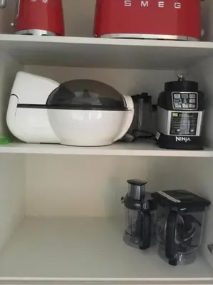 a kitchen appliance sitting on a shelf in a refrigerator at Fabulous 4 Bed Home with Gym in Basildon
