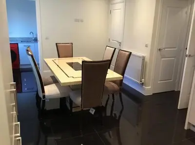 a dining room table and chairs in a room at Fabulous 4 Bed Home with Gym in Basildon
