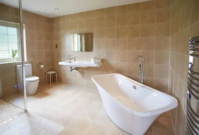 a bathroom with a tub and a sink and a toilet at Endymion Lodge in Chappel