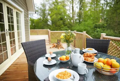 a table with plates of food on a patio at Endymion Lodge in Chappel
