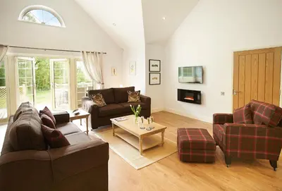 a living room with two couches and a table at Ramson Lodge in Chappel