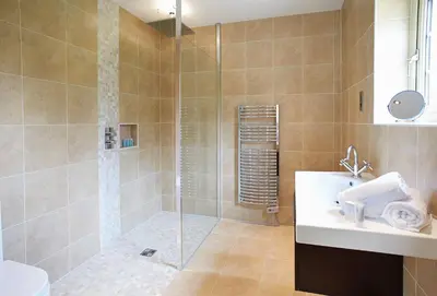 a bathroom with a shower and a toilet and a sink at Ramson Lodge in Chappel