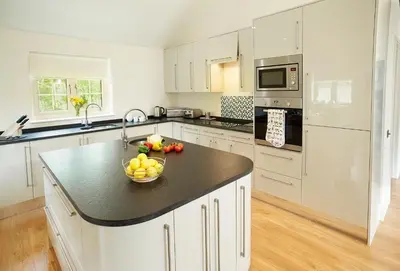 a kitchen with a bowl of fruit on a counter at Campion Lodge in Chappel