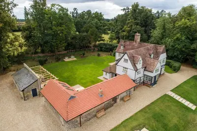 an aerial view of a large house with a yard at The Farmhouse, Nether Hall Estate in Pakenham