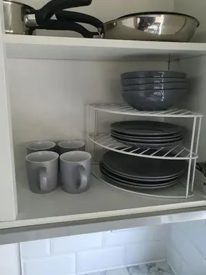 a white cabinet filled with plates and bowls and dishes at Awave From It All - Escape the city life in Jaywick Sands