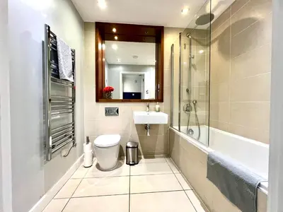 a bathroom with a toilet and a sink and a shower at Home2home - Mill Park in Cambridge
