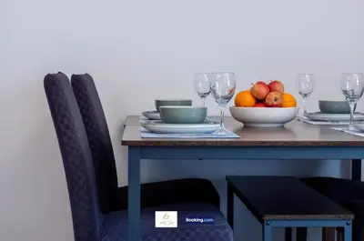 a table with a bowl of fruit and wine glasses at Centrally Located 3 Bedroom House By Trinity Stays Short Lets & Serviced Accommodation Cambridge in Cambridge