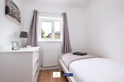 a bedroom with a bed and a dresser and a window at Centrally Located 3 Bedroom House By Trinity Stays Short Lets & Serviced Accommodation Cambridge in Cambridge