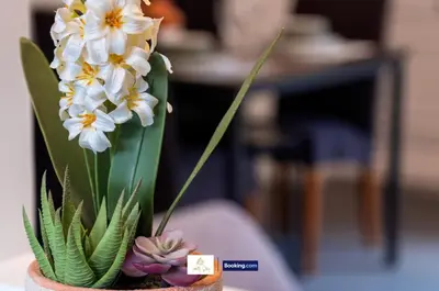 a vase with white and yellow flowers in it at Centrally Located 3 Bedroom House By Trinity Stays Short Lets & Serviced Accommodation Cambridge in Cambridge