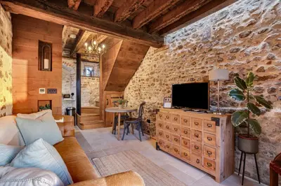 a living room with a tv on a wooden wall at Toll Barn, St Osyth Priory in Colchester