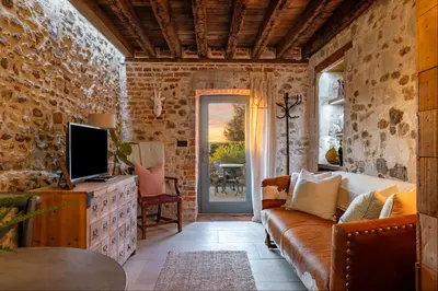 a living room with a couch and a tv at Toll Barn, St Osyth Priory in Colchester
