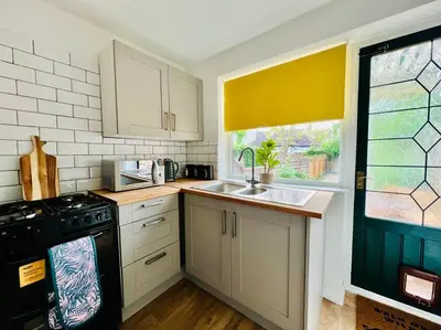 a kitchen with a sink and a stove and a window at Deluxe Apartment in Southend-On-Sea by Artisan Stays I Free Parking I Sleeps 5 in Southend-on-Sea