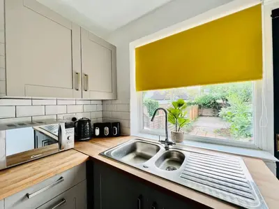 a kitchen with a sink and a window at Deluxe Apartment in Southend-On-Sea by Artisan Stays I Free Parking I Sleeps 5 in Southend-on-Sea