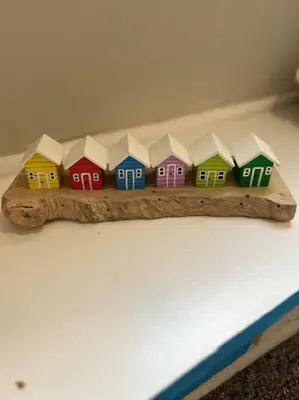 a group of colorful toy houses on a wooden shelf at Deluxe Apartment in Southend-On-Sea by Artisan Stays I Free Parking I Sleeps 5 in Southend-on-Sea