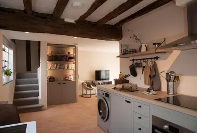 a kitchen with a washer and dryer in a room at Blacksmith's Cottage Suffolk in Lavenham