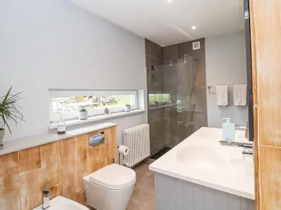a bathroom with a toilet and a sink and a shower at Polly's Annexe in Ipswich