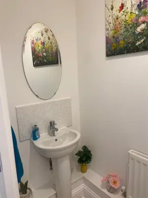 a bathroom with a sink and a mirror at Warm & Cosy Homely 4 BDR Chesterton House w High Speed WIFI, Big Garden & Free Parking in Cambridge
