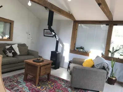 a living room with a couch and a wood stove at Garden View in Saxlingham Thorpe