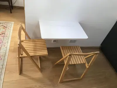 a desk and a wooden chair next to a table at Garden View in Saxlingham Thorpe