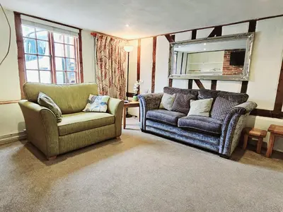 a living room with two chairs and a couch at Perfectly Located Pretty Cottage in Diss