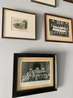 a group of pictures hanging on a wall at Scholar's Loft - Cosy & Close to Central Cambridge in Cambridge