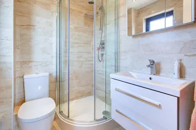 a bathroom with a shower and a toilet and a sink at Serene Family Escape - Spacious, Near Thorpe Bay and Southend, Beaches & Amenities - Pass the Keys in Southend-on-Sea