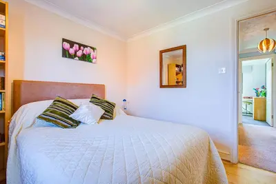 a bedroom with a white bed with two pillows at Serene Family Escape - Spacious, Near Thorpe Bay and Southend, Beaches & Amenities - Pass the Keys in Southend-on-Sea