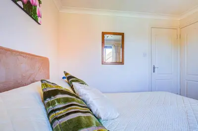 a bedroom with a bed with two pillows on it at Serene Family Escape - Spacious, Near Thorpe Bay and Southend, Beaches & Amenities - Pass the Keys in Southend-on-Sea