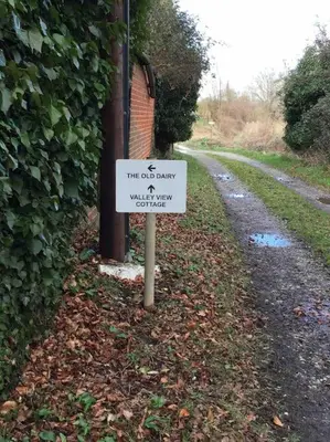 a sign sitting on the side of a road at The Old Dairy, Valley Farm, Middleton in Middleton