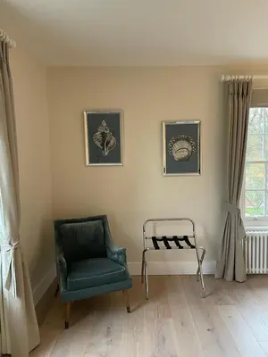 a living room with a chair and a window at Moulton Lawn House B&B in Moulton