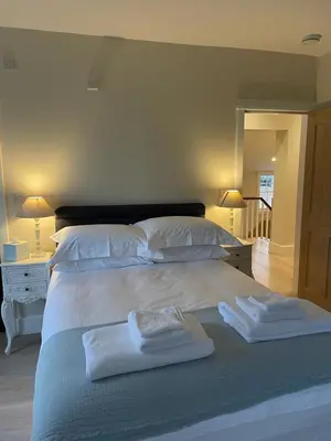 a bedroom with a bed with two towels on it at Moulton Lawn House B&B in Moulton