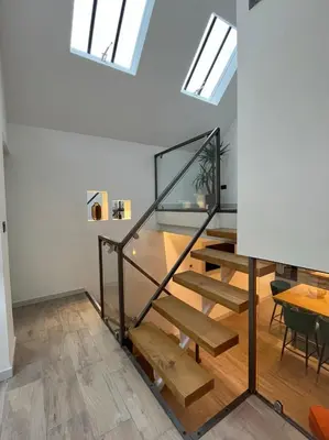 a room with a staircase and skylights at Emery Street Lodge in Cambridge