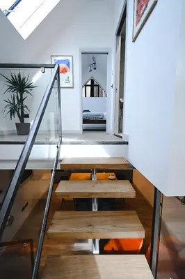 a staircase in a house with a bench on the floor at Emery Street Lodge in Cambridge