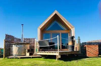 a tiny house with a gazebo at Lushna 1 Mezzanine at Lee Wick Farm Cottages & Glamping in Clacton-on-Sea