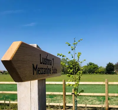 a sign for a wildlife magnification clinic in a field at Lushna 1 Mezzanine at Lee Wick Farm Cottages & Glamping in Clacton-on-Sea