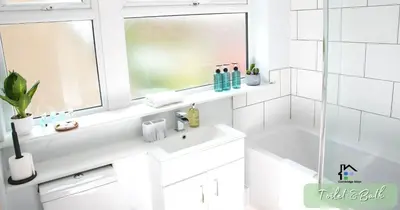 a white bathroom with a sink and a window at 4-5 Bedroom House Garden Lots of Parking 15 min to city Close to motorway in Girton