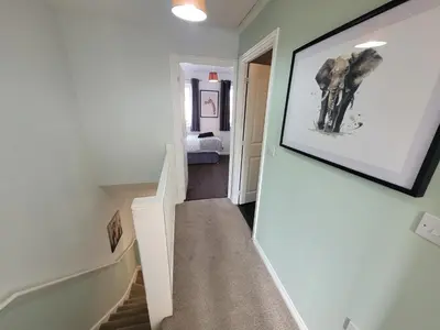 a stairway with a picture of an elephant on the wall at Kensington House- The Perfect home for contractor stays in Colchester