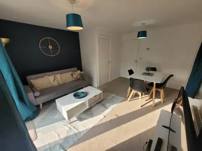 a living room with a couch and a table at Kensington House- The Perfect home for contractor stays in Colchester