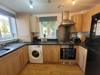 a kitchen with a washer and dryer in it at Kensington House- The Perfect home for contractor stays in Colchester