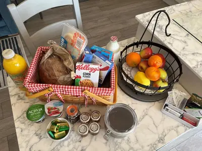 a table with a basket of food and a basket of fruit at The Retreat Field View in Little Maplestead