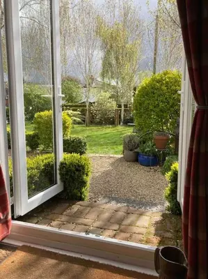 an open window with a view of a garden at The Cabin in Hockham