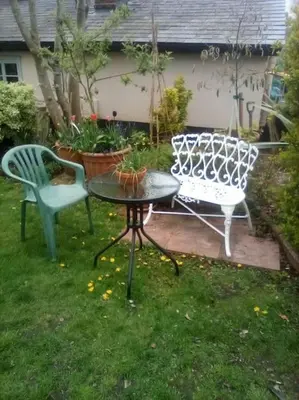a patio with two chairs and a table and a table and chairs at The Cabin in Hockham