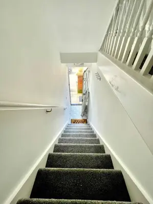 a staircase in a building with a stair case at High-End 2 Bed Maisonette in Beaulieu Park in Broomfield