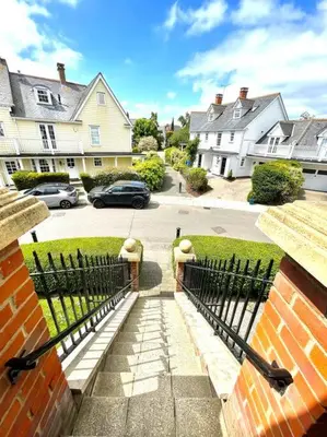 a black fence in front of a house at High-End 2 Bed Maisonette in Beaulieu Park in Broomfield