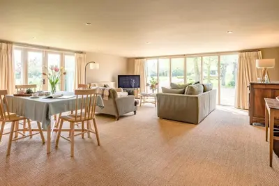 a large living room with a table and chairs at Gardiners Cottage Barn, Braiseworth in Eye