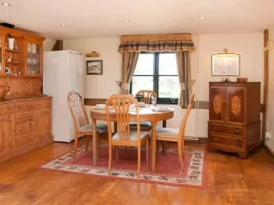 a dining room with a table and chairs and a window at Paddock Barn ~ Short & Long term stay, pets welcome ~ Woodbridge, Framlingham ar in Cretingham