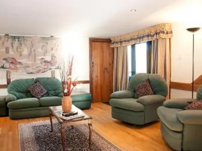 a living room with two green couches and a table at Paddock Barn ~ Short & Long term stay, pets welcome ~ Woodbridge, Framlingham ar in Cretingham